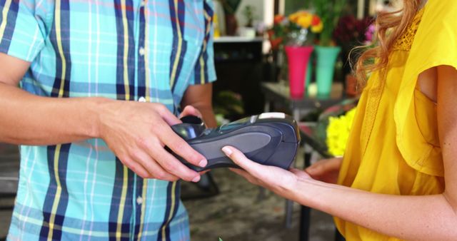 Close-Up of Customer Paying with Contactless Payment in Flower Shop - Download Free Stock Images Pikwizard.com