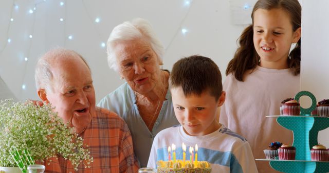 Multi generation family celebrating birthday. cake on table with candels 4k