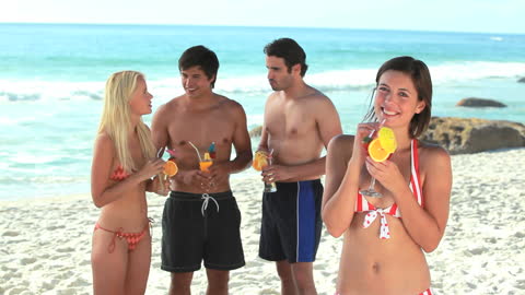 Group of Friends Relaxing at Beach with Refreshing Cocktails