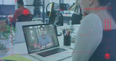 Office worker engaged in remote collaboration via laptop