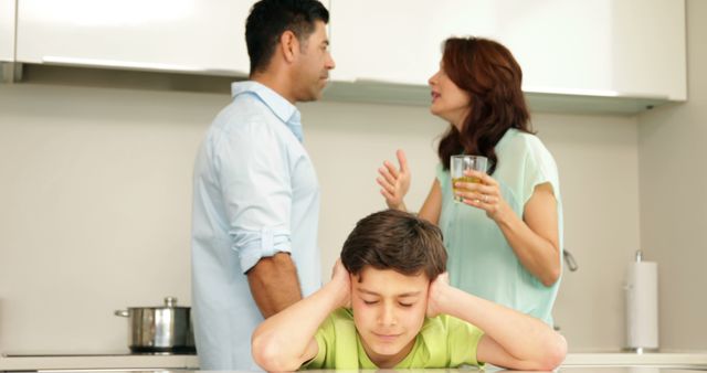 Parents arguing while child looks stressed in kitchen - Download Free Stock Images Pikwizard.com