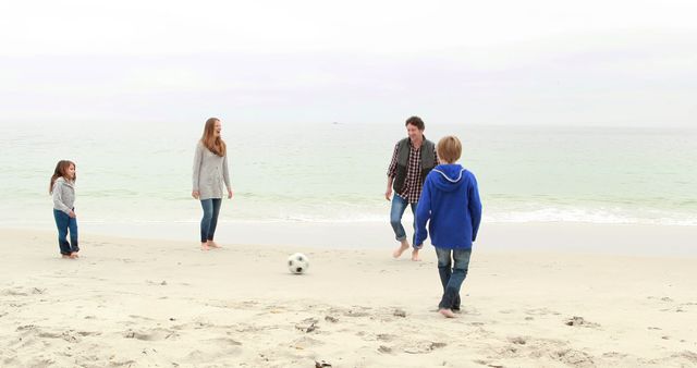 Family Playing Soccer on Beach in Casual Attire - Download Free Stock Images Pikwizard.com