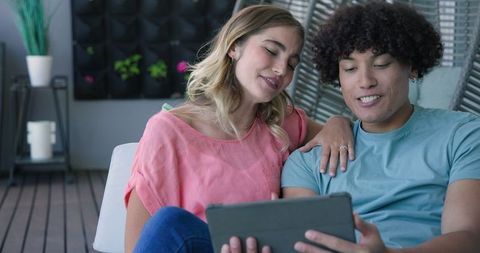Happy Couple Enjoying Tablet at Home, Relaxing Together