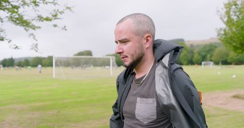 Man Walking in Park Enjoying Outdoor Leisure and Relaxation
