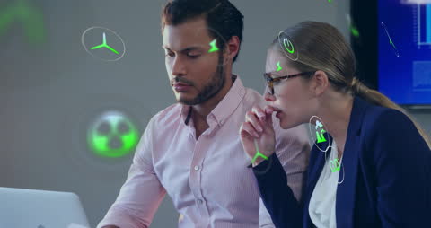 Diverse Business Team Analyzing Eco-Friendly Data Visualizations