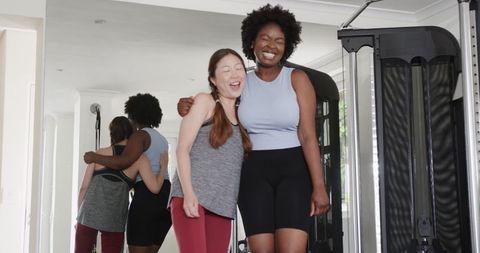 Diverse Women Celebrating Fitness Achievements in Gym