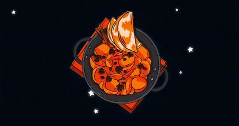 Seafood stew simmering in rustic black pot with shrimp and clams, orange broth, wooden chopsticks