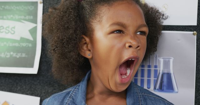 Tired child yawning in classroom environment - Download Free Stock Images Pikwizard.com