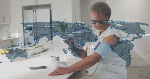 Senior woman using blood pressure monitor with digital map overlay