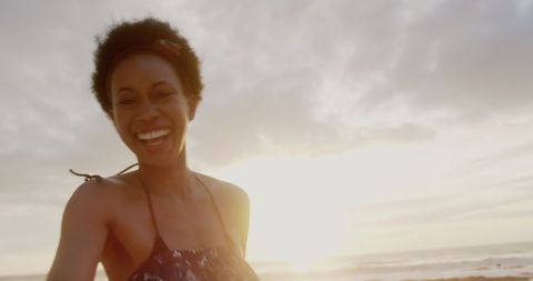Joyful African American Woman Enjoying Sunset at Beach