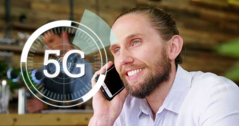 Man enjoying 5g connectivity at cafe, smiling and conversing