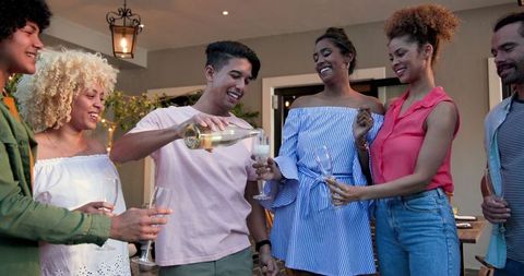 Friends Laughing and Enjoying Celebration Al Fresco