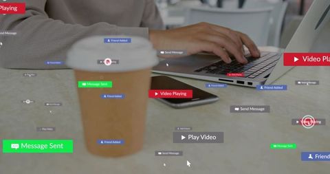Typing remote worker using laptop in cafe with coffee and smartphone plus social overlays
