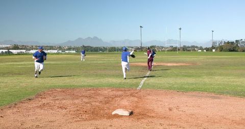 Exciting baseball action: first baseman catches ball at first base