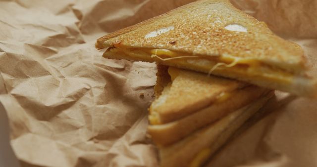Image of close up of toasted cheese sandwiches on brown paper over grey background. fusion food and freshly made food concept.