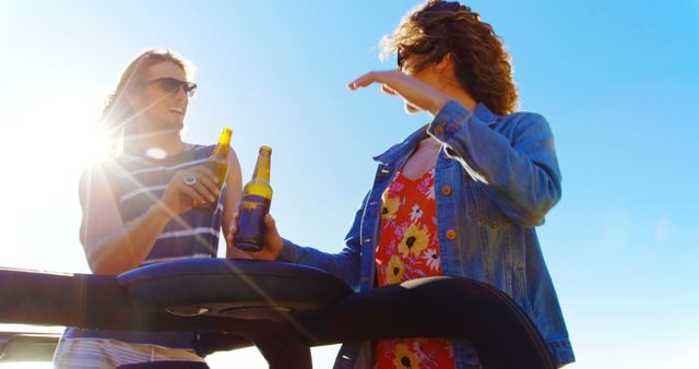 Friends Enjoying Sunlit Day with Beer by Beach - Download Free Stock Images Pikwizard.com