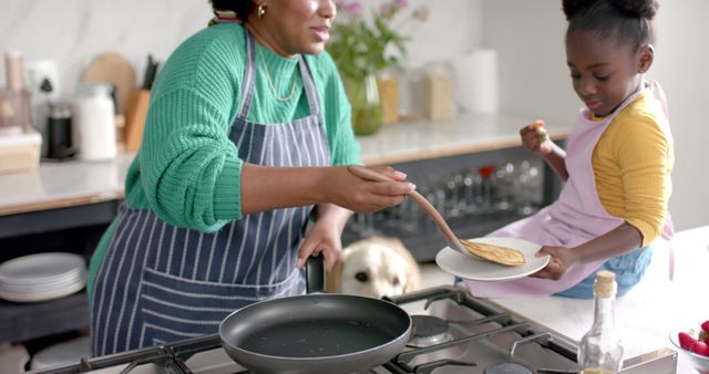 Mother and Daughter Cooking Pancakes Together in Modern Kitchen - Download Free Stock Images Pikwizard.com