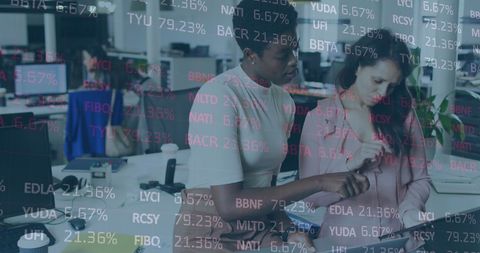 Businesswomen Collaborating on Data Processing in Modern Office