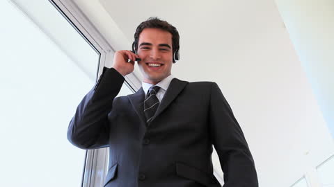 Confident Businessman Using Headset in Modern Office