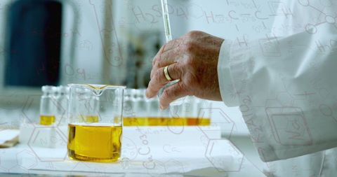 Scientist Conducting Experiment with Yellow Liquid in Laboratory - Download Free Stock Images Pikwizard.com