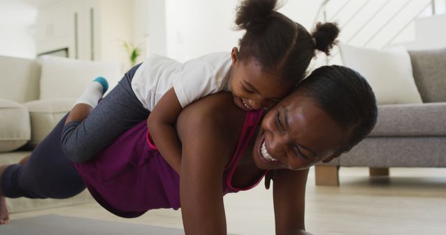 Mother Exercising At Home With Daughter Piggyback - Download Free Stock Images Pikwizard.com