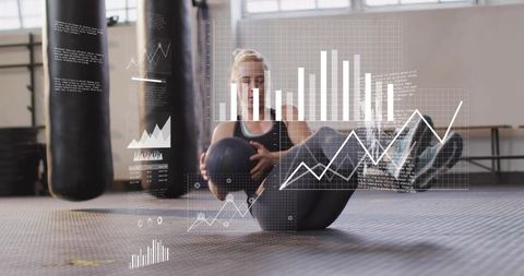 Female athlete performing v-sit with medicine ball and fitness analytics overlays