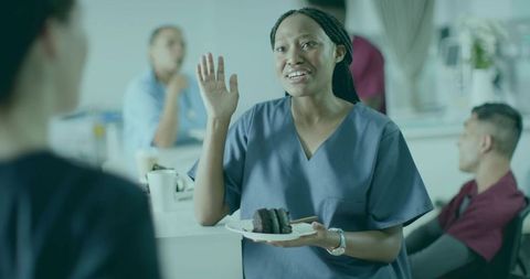 Healthcare Professional Holding Cake in Staff Lounge