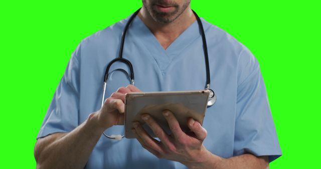 Doctor in Scrubs Using Tablet on Green Screen Background - Download Free Stock Images Pikwizard.com