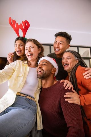 Diverse Friends Celebrating Christmas Smiling for Group Selfie
