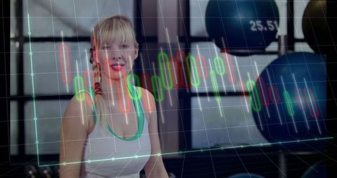 Active Woman in Fitness Studio Analyzing Performance Trends