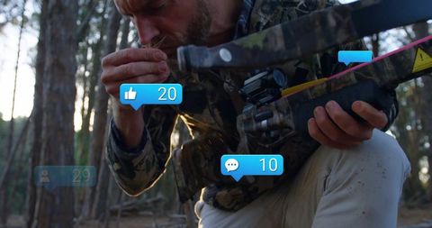 Camouflage Hunter Analyzing Environment in Pine Forest Outdoors