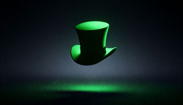 Hovering Vivid Green Top Hat Casting Glowing Emerald Halo and Pool Light Over Dark Surface