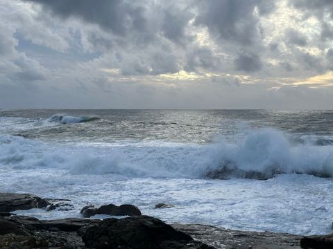 Dramatic beach waves crashing against rocky coastline