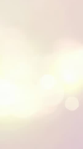 Vertical pastel bokeh lights pulsing on soft abstract backdrop for calming motion visuals