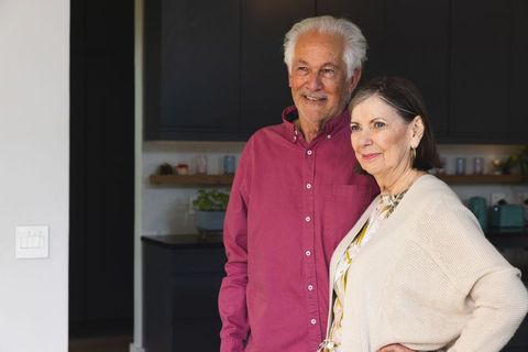 Senior Couple in Modern Kitchen Smiling Together at Home