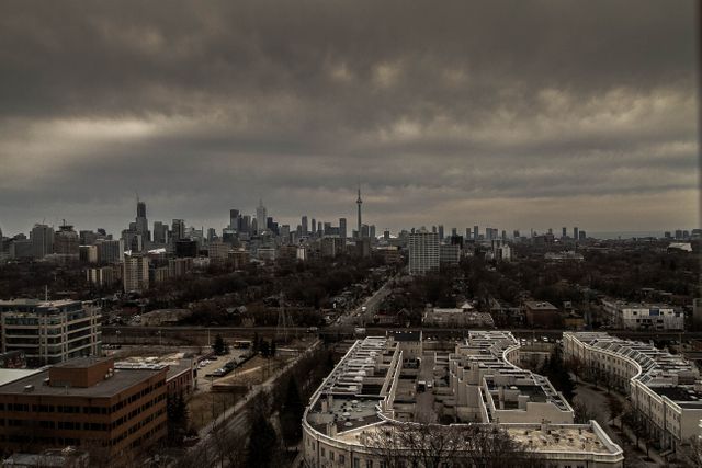 Perfect for illustrating moody urban scenes, city planning reports, or Toronto travel guides. Shows uptown view with overcast sky, emphasizing industrial and urban development. Fathomable in news articles about weather or city infrastructure.
