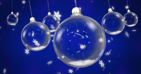 Floating glass baubles with snowflakes on blue background