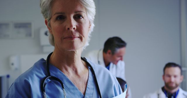 Confident Female Doctor Standing with Colleagues in Hospital - Download Free Stock Images Pikwizard.com