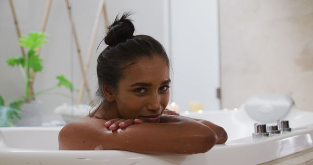 Young Woman Relaxing in Bathtub with Green Plants and Candles - Download Free Stock Images Pikwizard.com