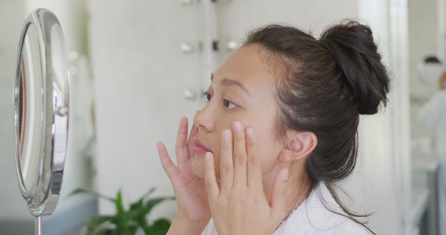 Young Woman Practicing Skincare Routine in Bathroom Mirror - Download Free Stock Images Pikwizard.com