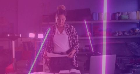 Technician Reviewing Blueprints in Modern Garage Workshop