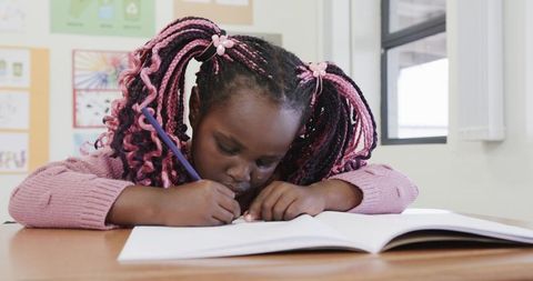 Focused Young Girl Writing at School Desk Enhancing Learning Skills