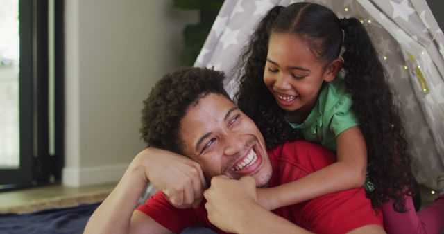 Happy biracial father and daughter embracing and smiling - Download Free Stock Photos Pikwizard.com