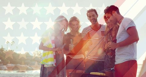 Friends Enjoying Beach BBQ with USA Flag Overlay
