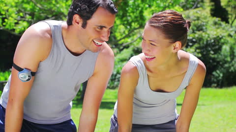 Couple Relaxing After Jogging in Park