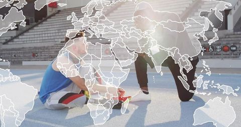 Coach guiding athlete tying shoelaces on track with world map overlay and sunlight