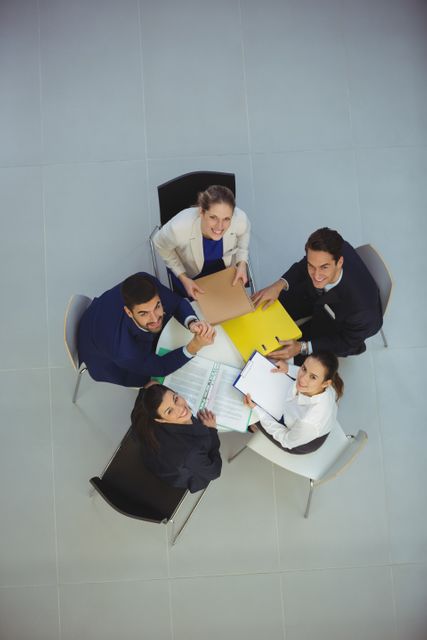 Business team having discussion and planning strategies during meeting at office. This image is ideal for illustrating corporate environments, teamwork, and brainstorming sessions in business presentations, reports, and company websites.