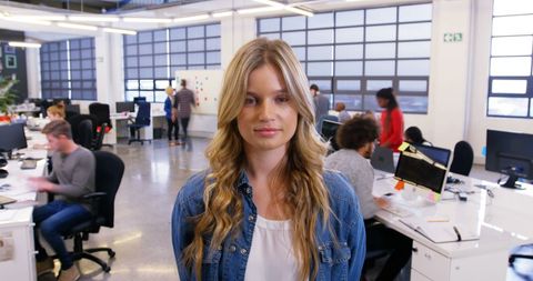 Confident Businesswoman Standing in Vibrant Office Space