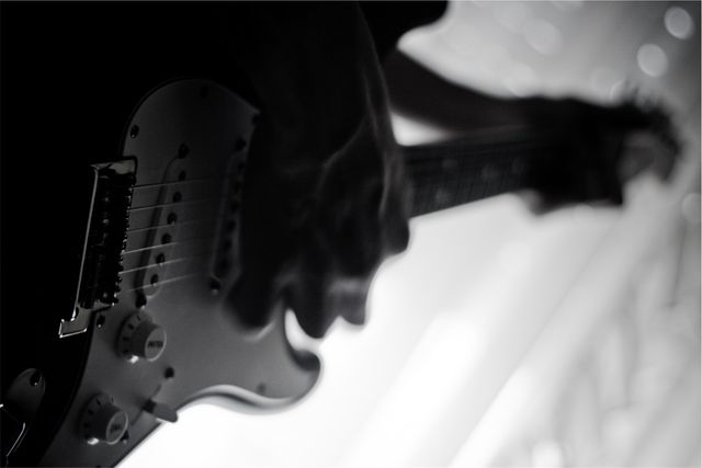 Close-up of Electric Guitar Performance in Black and White - Download Free Stock Photos Pikwizard.com