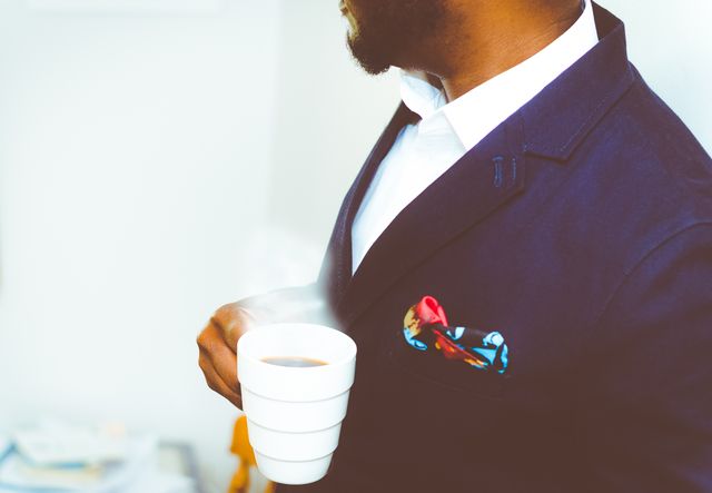Man in Suit Holding Coffee Cup with Colorful Pocket Square - Download Free Stock Photos Pikwizard.com